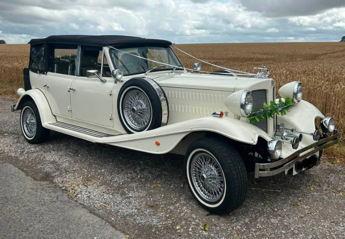 Ivory Beauford tourer dressed with white ribbons, on a country lane beside a Sussex cornfield